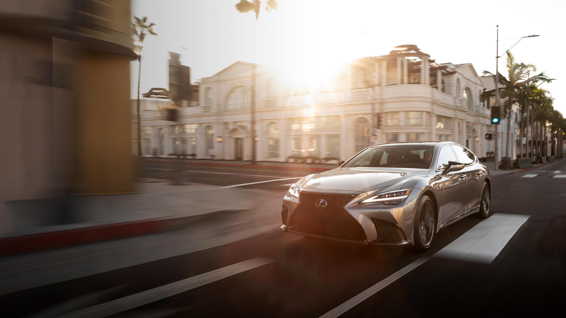Silver Lexus LS being driven on the road.​