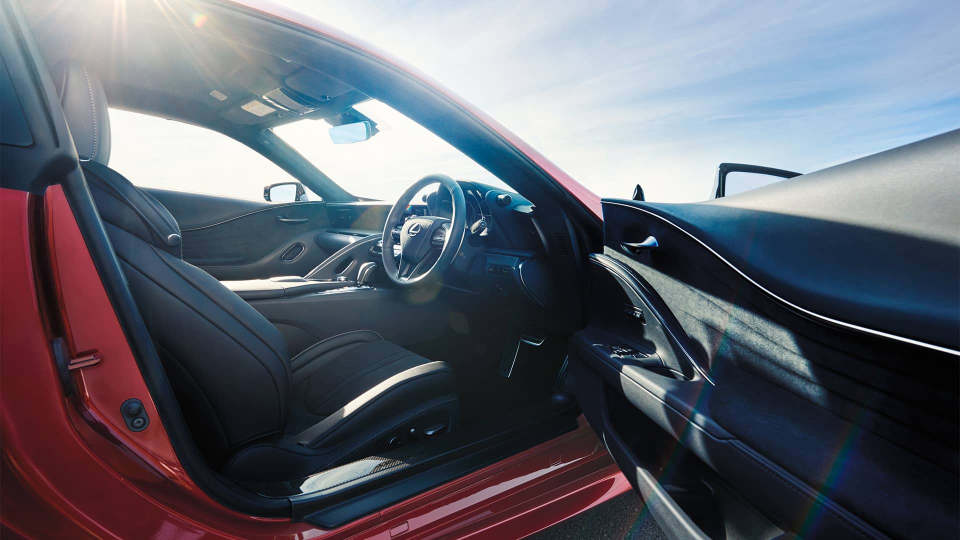Close up of the driver’s seat of a red Lexus LC. Book a test drive to experience the pleasure of driving a Lexus. 
